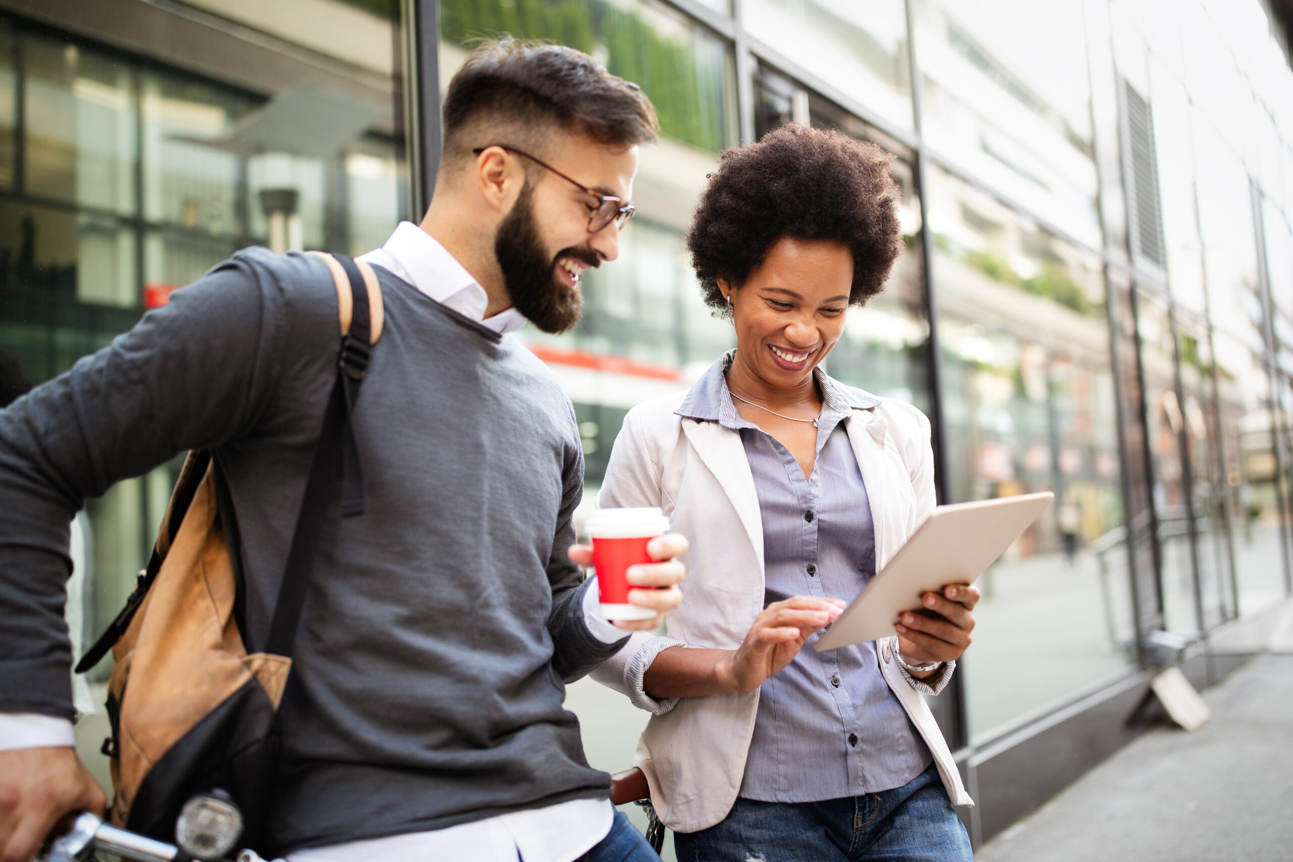 Two marketing professionals learning how to measure brand awareness offline